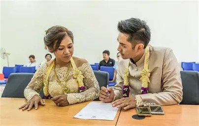A Thai couple registering their marriage at the local amphur office