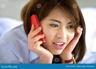 A Thai girl phoning her parents